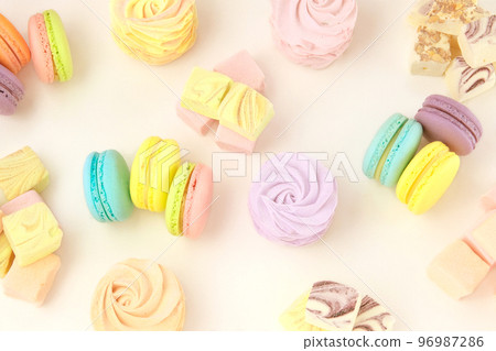 Various of desserts: macaroons, marshmallows and zephyrs. Traditional colored sweet desserts for the holiday. Top view. 96987286