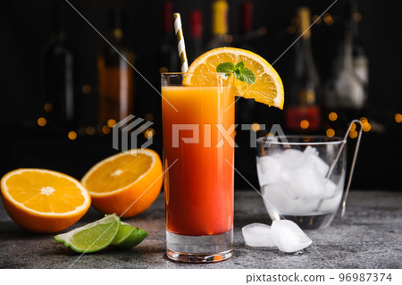 Fresh alcoholic Tequila Sunrise cocktail on grey table 96987374