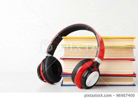 Books and modern headphones on white background. Space for text Books and modern headphones on white background. Space for text 96987400