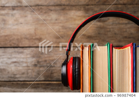 Books and modern headphones on wooden background, closeup. Space for text Books and modern headphones on wooden background, closeup. Space for text 96987404