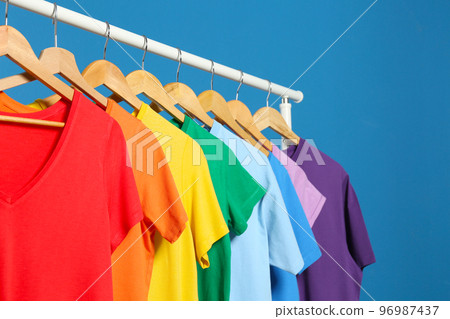 Bright clothes on blue background. Rainbow colors 96987437