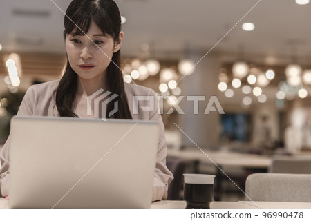 A woman thinking while looking at materials 96990478