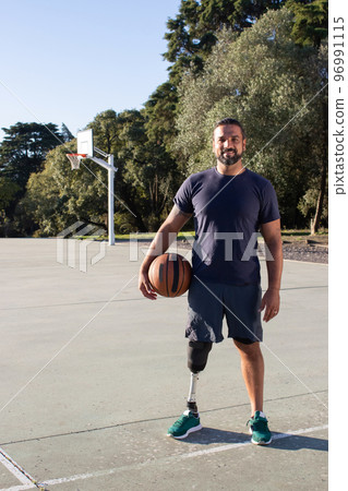 Smiling Hispanic man with physical disability standing 96991115