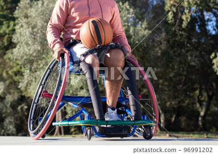 Man of unrecognizable age sitting in sport wheelchair 96991202