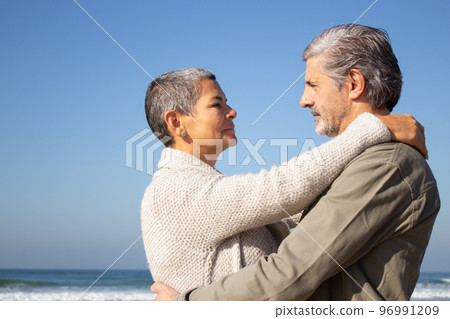 Gray-haired senior couple hugging at seashore Gray-haired senior couple hugging at seashore 96991209