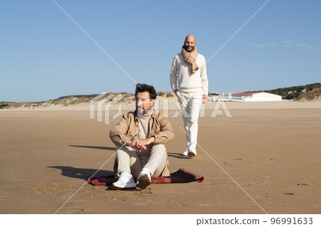 Gay man waiting for lover on beach Gay man waiting for lover on beach 96991633