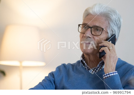 Mature businessman talking on phone at phone 96991794