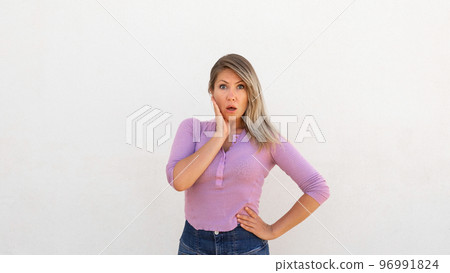 Surprised Caucasian woman touching face Surprised Caucasian woman touching face 96991824