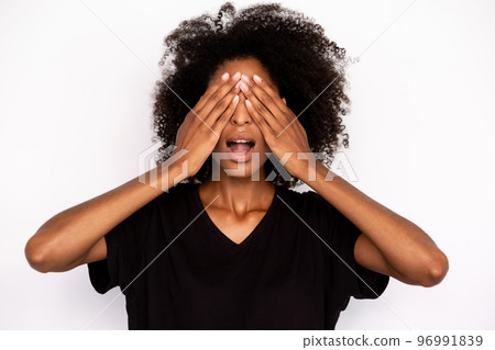 Close-up of excited young woman covering eyes with hands 96991839