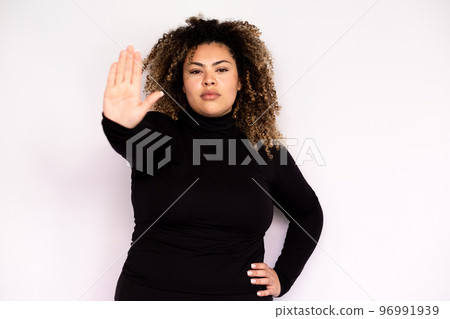 Serious young woman showing stop sign 96991939