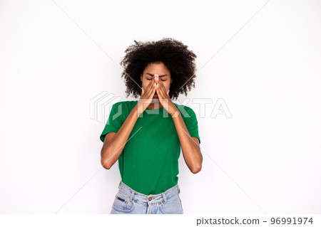 Portrait of tired young woman rubbing nose over white background 96991974