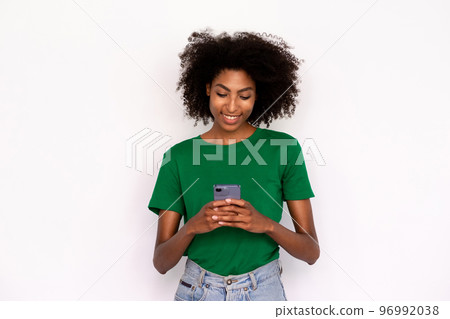Portrait of happy young woman texting or reading message Portrait of happy young woman texting or reading message 96992038