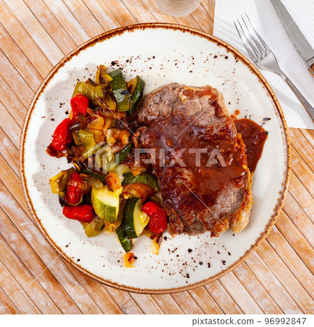 Grilled veal steak with braised vegetables Grilled veal steak with braised vegetables 96992847