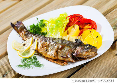 Grilled trout with vegetable garnish 96993231