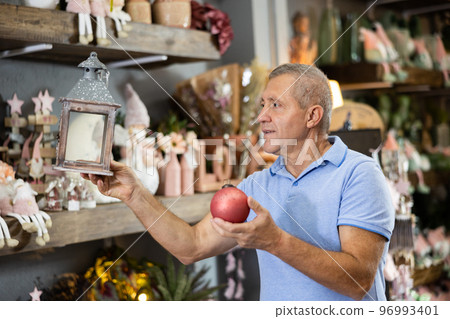 Man selecting christmas decorations in store 96993401