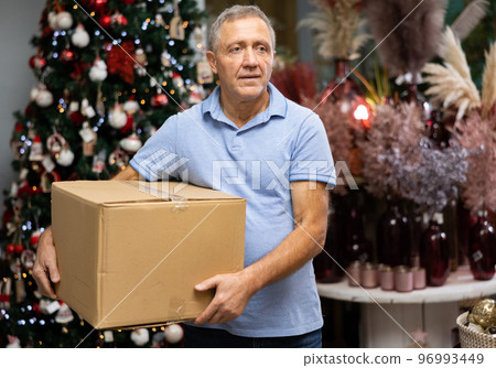 Portrait of man with pasteboard box in christmas market 96993449