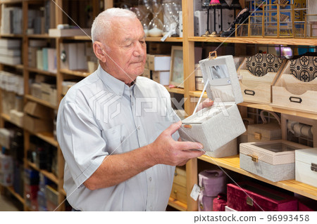 Man choosing jewelry storage box at store Man choosing jewelry storage box at store 96993458