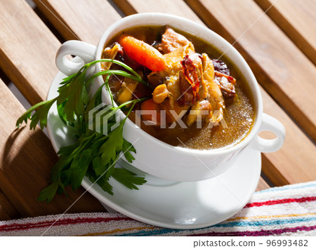 Scottish traditional soup of chicken, bacon and leek, served in bowl 96993482