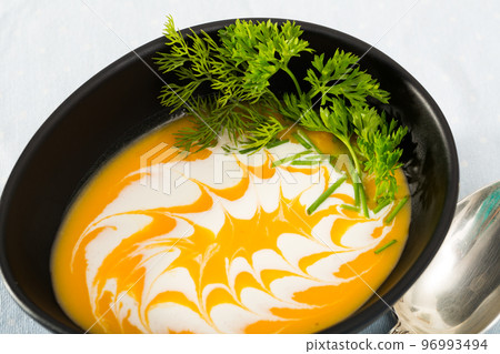 Tasty homemade rustic pumpkin and ginger soup puree in ceramic bowl Tasty homemade rustic pumpkin and ginger soup puree in ceramic bowl 96993494