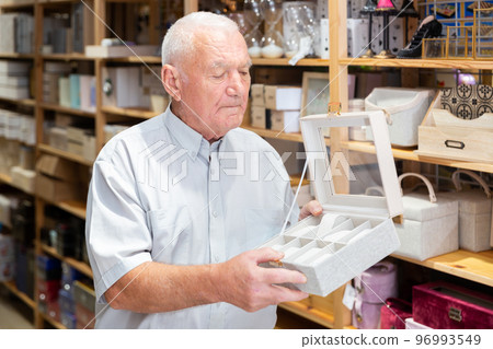 Man choosing jewelry storage box at store Man choosing jewelry storage box at store 96993549