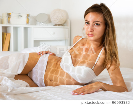 Girl with perfect body posing in bed 96993583