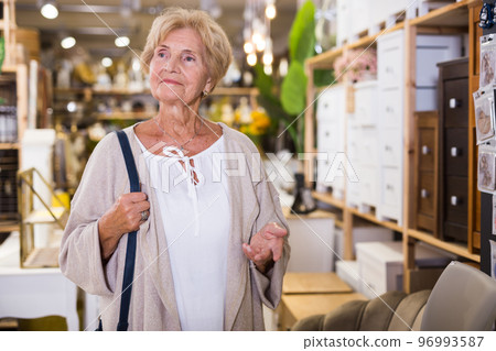 Active senior woman shopping at household store 96993587