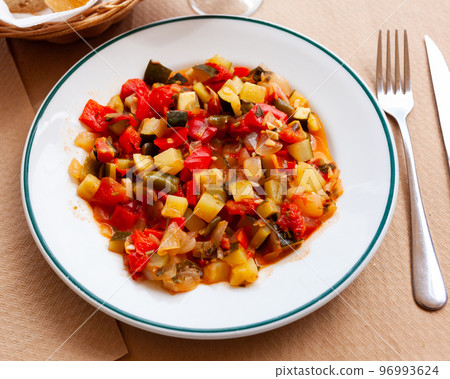 Plate of stewed vegetables on table. Vegetarian dish 96993624