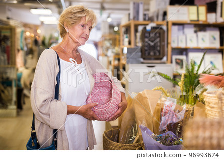 Active senior woman shopping at household store Active senior woman shopping at household store 96993674
