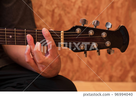 Hand playing the guitar guitar 96994040