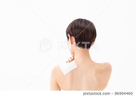 A woman applying a poultice 96994460