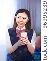 Female student operating a smartphone 96995239