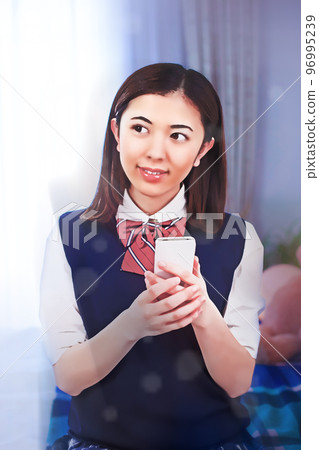 Female student operating a smartphone Female student operating a smartphone 96995239