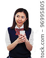 Female student operating a smartphone 96995805