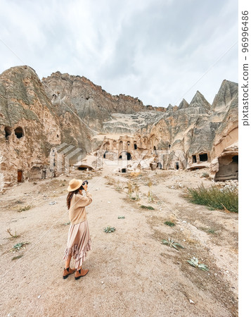 Young woman touring cave church in Cappadocia 96996486
