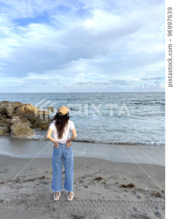 Young beautiful woman relax on the beach Young beautiful woman relax on the beach 96997639