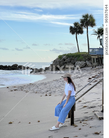 Young beautiful woman relax on the beach Young beautiful woman relax on the beach 96997644
