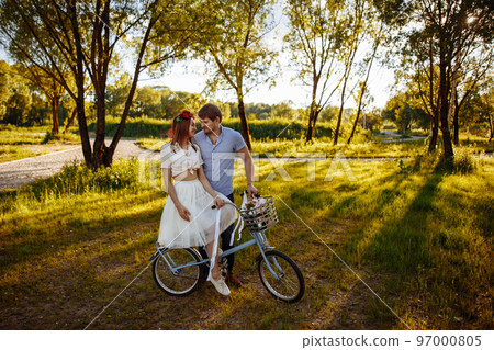 Loving couple on vintage bike Loving couple on vintage bike 97000805
