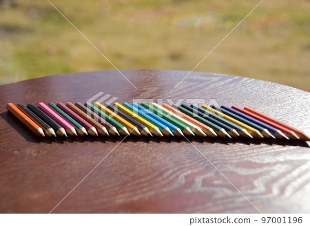 A lot of colored pencils in the warm sunlight 97001196