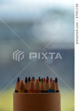 A lot of colored pencils in the warm sunlight 97001198
