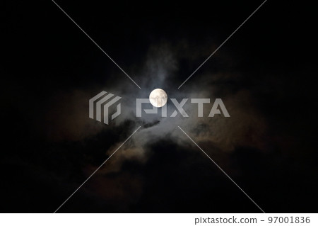Full moon peeking through the clouds 97001836