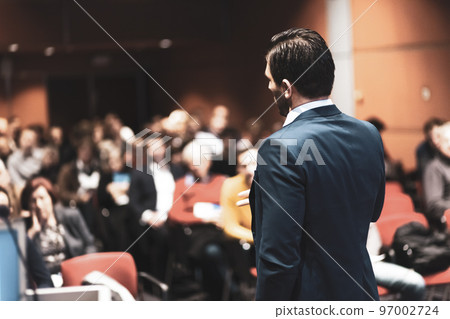 Speaker giving a talk on corporate Business Conference. Audience at the conference hall. Business and Entrepreneurship event. Speaker giving a talk on corporate Business Conference. Audience at the conference hall. Business and Entrepreneurship event. 97002724