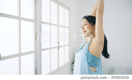woman stretching indoors 97003030