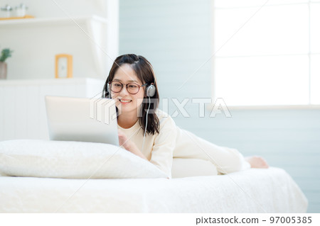 在筆記本電腦上觀看視頻的年輕女性 97005385