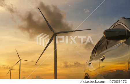 Close-up car in with wind turbines and sunset backgrounds. Close-up car in with wind turbines and sunset backgrounds. 97005472