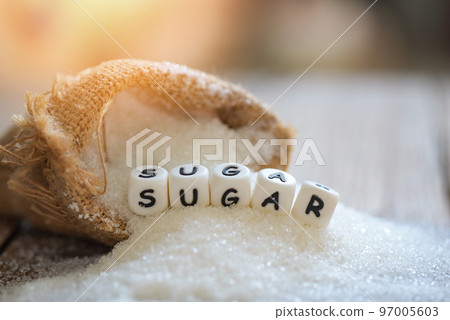 Sugar on sack and wooden background, white sugar for food and sweets dessert candy heap of sweet sugar crystalline granulated 97005603