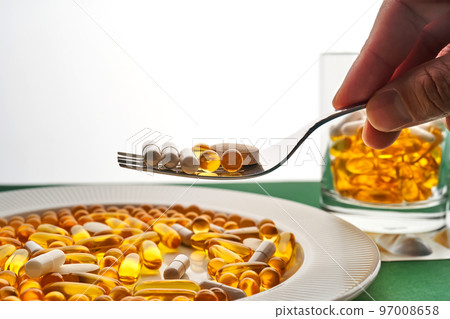 A plate and a glass with vitamins and other medical preparations. A plate and a glass with vitamins and other medical preparations. 97008658