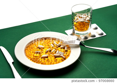 A plate and a glass with vitamins and other medical preparations. 97008660