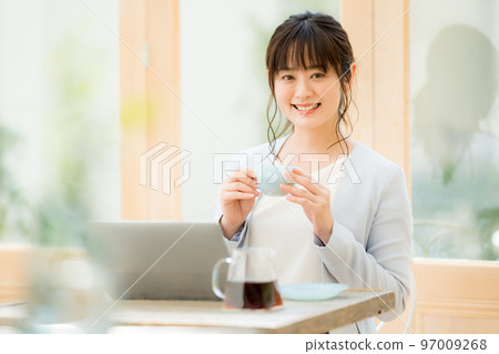 A woman doing nomad work at a cafe A woman doing nomad work at a cafe 97009268