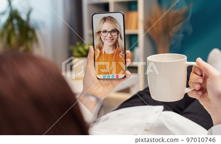 Video call with daughter using smartphone Video call with daughter using smartphone 97010746