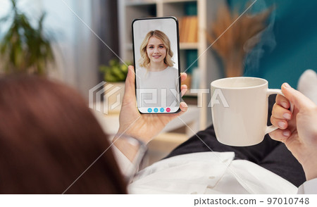 Video call with daughter using smartphone Video call with daughter using smartphone 97010748